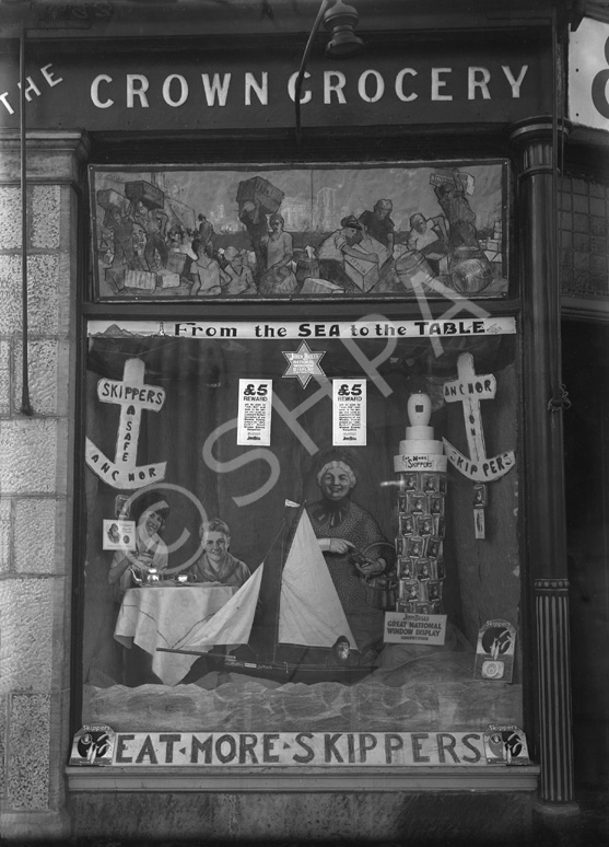 Ettles Crown Grocery, Inverness December 1927. Window display for Skippers tinned fish, an entrant in the John Bull's Great National Window Display competition. Now Chris Crook Hairdressers on the corner of Charles Street, Inverness. (2009).*