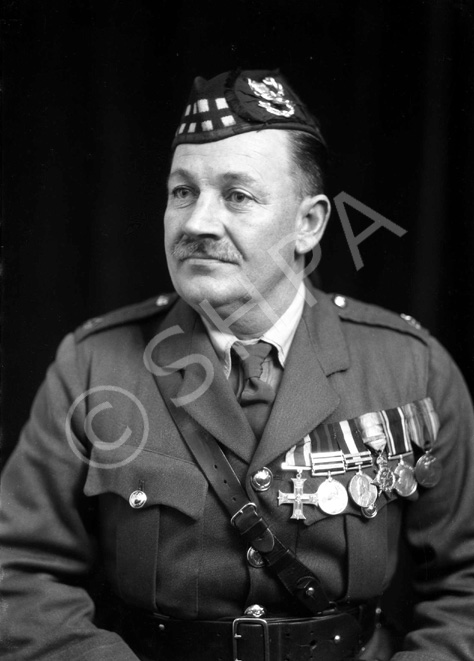 Major Donald Munro MC (1880-1932). He had been stationed at Fort George from 1921 until his death of pneumonia on 8 December 1932. His medals are the Military Cross (1915), Queen's South Africa Medal (1900), King's South Africa Medal (1902), the 1914 Star, British War Medal and Allied Victory Medal. 

A native of the Ardross district, the deceased came to Dingwall early in his youth and for a time served on the clerical staff of the late Mr William Paterson, corn and coal merchant, Dingwall. From there, he enlisted in The Seaforth Highlanders at Fort George on 8 February 1898 and he served with his regiment for exactly one month short of 34 years.

Major Munro had a very distinguished military career, starting as private, rising through all the grades, was commissioned on the field of war and in December 1929, he received his majority.

Enlisting at Fort George on 8 February 1898, he was posted to and joined the 2nd Battalion at Dover two days later. He served with the 2nd Battalion through the South African War, being present at the action at Whittebergen. He also took part in the guerrilla warfare towards the close of hostilities in the Transvaal and Cape Colony. He received the Queen's Medal with three clasps and the King's Medal, with two clasps. From South Africa he went to Ireland.

Appointed Lance Corporal in 1899, he was promoted Corporal in August 1903 and Sergeant in 1907. Whilst serving with the 2nd Battalion he was promoted Regimental Quartermaster Sergeant just prior to the outbreak of the Great War in 1914. He proceeded with the 2nd Battalion to France in 1914 and obtained a regular commission as Lieutenant on 1 October1915. He was appointed Lieutenant and Quartermaster and was promoted to Captain and Quartermaster on 1 October 1917, receiving his majority on 1 October 1929. For his services in the War, he received the Military Cross, as well as the 1914 Star, the British War Medal and the Victory Medal. He came home from France in February 1919 and in November of that year he was in India with the battalion. In December 1921, he was posted from the 2nd Battalion at Meerut, India, to the Depot, Fort George.

As private, NCO, and officer, Major Munro was ever popular in his regiment, his chubby, round, smiling face being a source of happiness to his companions, to the men under him and to his fellow officers. He was recognised for his ability as a statistician, his integrity and perfect fairness, his courtesy and willingness to serve others, and above all his love of his regiment, the history and traditions of which he knew, chapter and verse.

His funeral took place from Fort George to Ardersier Cemetery with Military and Masonic honours. The gathering of mourners was large and was representative of the military life of the Highlands. The numerous, beautiful wreaths bore ample testimony to the respect and popularity in which the late officer was held. A short service at the house was followed by an impressive service in the Garrison Church, conducted by the Rev. William Graham, Ardersier, who also officiated at the service at the graveside.

 Taken from his Obituary in The Ross-shire Journal