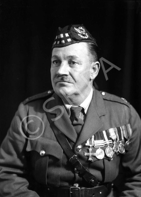 Major Donald Munro MC (1880-1932). He had been stationed at Fort George from 1921 until his death of pneumonia on 8 December 1932. His medals are the Military Cross (1915), Queen's South Africa Medal (1900), King's South Africa Medal (1902), the 1914 Star, British War Medal and Allied Victory Medal. 

A native of the Ardross district, the deceased came to Dingwall early in his youth and for a time served on the clerical staff of the late Mr William Paterson, corn and coal merchant, Dingwall. From there, he enlisted in The Seaforth Highlanders at Fort George on 8 February 1898 and he served with his regiment for exactly one month short of 34 years.

Major Munro had a very distinguished military career, starting as private, rising through all the grades, was commissioned on the field of war and in December 1929, he received his majority.

Enlisting at Fort George on 8 February 1898, he was posted to and joined the 2nd Battalion at Dover two days later. He served with the 2nd Battalion through the South African War, being present at the action at Whittebergen. He also took part in the guerrilla warfare towards the close of hostilities in the Transvaal and Cape Colony. He received the Queen's Medal with three clasps and the King's Medal, with two clasps. From South Africa he went to Ireland.

Appointed Lance Corporal in 1899, he was promoted Corporal in August 1903 and Sergeant in 1907. Whilst serving with the 2nd Battalion he was promoted Regimental Quartermaster Sergeant just prior to the outbreak of the Great War in 1914. He proceeded with the 2nd Battalion to France in 1914 and obtained a regular commission as Lieutenant on 1 October1915. He was appointed Lieutenant and Quartermaster and was promoted to Captain and Quartermaster on 1 October 1917, receiving his majority on 1 October 1929. For his services in the War, he received the Military Cross, as well as the 1914 Star, the British War Medal and the Victory Medal. He came home from France in February 1919 and in November of that year he was in India with the battalion. In December 1921, he was posted from the 2nd Battalion at Meerut, India, to the Depot, Fort George.

As private, NCO, and officer, Major Munro was ever popular in his regiment, his chubby, round, smiling face being a source of happiness to his companions, to the men under him and to his fellow officers. He was recognised for his ability as a statistician, his integrity and perfect fairness, his courtesy and willingness to serve others, and above all his love of his regiment, the history and traditions of which he knew, chapter and verse.

His funeral took place from Fort George to Ardersier Cemetery with Military and Masonic honours. The gathering of mourners was large and was representative of the military life of the Highlands. The numerous, beautiful wreaths bore ample testimony to the respect and popularity in which the late officer was held. A short service at the house was followed by an impressive service in the Garrison Church, conducted by the Rev. William Graham, Ardersier, who also officiated at the service at the graveside.

 Taken from his Obituary in The Ross-shire Journal