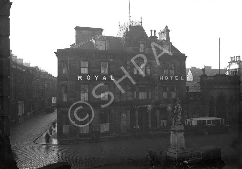 Royal Hotel Inverness, Academy Street, showing vintage car and bus, and Cameron Monument in Station Square, in the rain. Now occupied by the Clydesdale Bank. Monument to Queen's Own Cameron Highlanders who died in Egypt and the Nile campaign 1882-1887. Made from Portland stone it was unveiled in 1893. 04.12.1930.*
