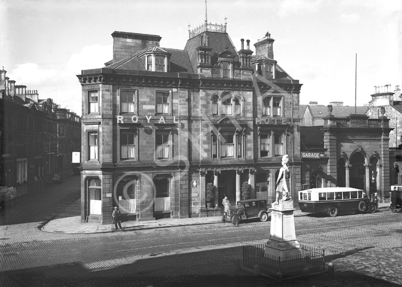 Royal Hotel Inverness, Academy Street, showing vintage car and bus, soldier memorial in Station Square, sunny day. Now occupied by the Clydesdale Bank. Monument to Queen's Own Cameron Highlanders who died in Egypt and the Nile campaign 1882-1887. Made from Portland stone it was unveiled in 1893. December 1930.*