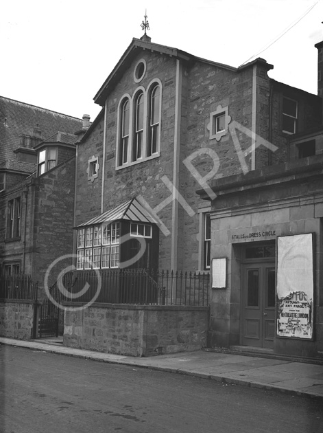 Bank Street, Inverness. The central building was used as the headquarters of Inverness District Scouts from 1931 to 1935, being then known as the Maud Lawson Hall, after Lady Maud Lawson of Dochfour, who had been a keen supporter of Scouting. The building was opened on 23rd June 1931 by the Prince of Wales, but was sold due to structural problems only four year later. Before 1931 the building was known as the Royal Halls. The Theatre Royal, on the far right,  burned down in 1934, causing a stir in Inverness at the time as people thought it had been predicted by the Brahan Seer who said that when a theatre in Inverness was built between two churches, it would be destroyed by fire. The theatre was situated on the riverside between the Free North Church and the St Columba Church. The building on the far left now houses the Riverside Gallery, and the central building is where CYC is located. Moray House now occupies the site where the Theatre Royal stood.* 