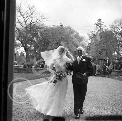 Innes - Jones bridal, Grantown-on-Spey. Bride and father entering the Church of Scotland in Grantown-on-Spey on Grant Road. A partial list of relatives to whom prints were to be posted includes: Mr & Mrs F. Innes, 19 Montgarrie Road, Alford, Aberdeenshire. Mr & Mrs J.R. Jones, 65 Hudspeth Crescent, Pity Me, Durham. Mr & Mrs P. Innes, 9 Scotland Place, Boness. Mr & Mrs A. Innes, 'Kent Wynds,' Hever Avenue, West Kingsdown, Kent. Mr & Mrs J. Innes, 'Elmwood,' Townhead Road, Strathaven, Lanarkshire and Mrs P. Innes, 'Carndearg,' Grantown-on-Spey.