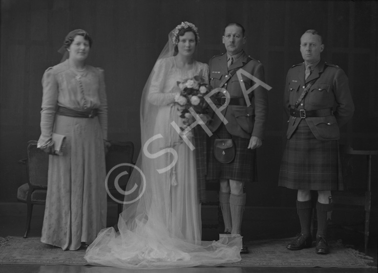 Major & Mrs Fraser, bridal. Major James W. Fraser was born in 1893 at Crask of Aigas, Beauly, and served in the Queen's Own Cameron Highlanders from 1910 to 1939. On 15th February 1943 married Miss Nancy Ford, daughter of Major John Ford DCM, late Cameron Highlanders, and Mrs Ford, Inverness. With Major A.F. MacGillivray, the best man, and Miss M. McLeod. 