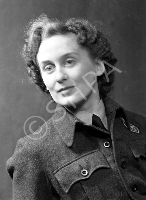 Miss MacDonald, 27 Telford Gardens. She is wearing the badge of the Royal Observer Corps. .....