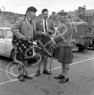 Matheson (on right) talking with pipers in the car park of what is now Farraline Park Bus Station, I.....