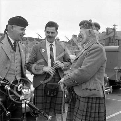 Matheson (on right) talking with pipers in the car park of what is now Farraline Park Bus Station, Inverness.