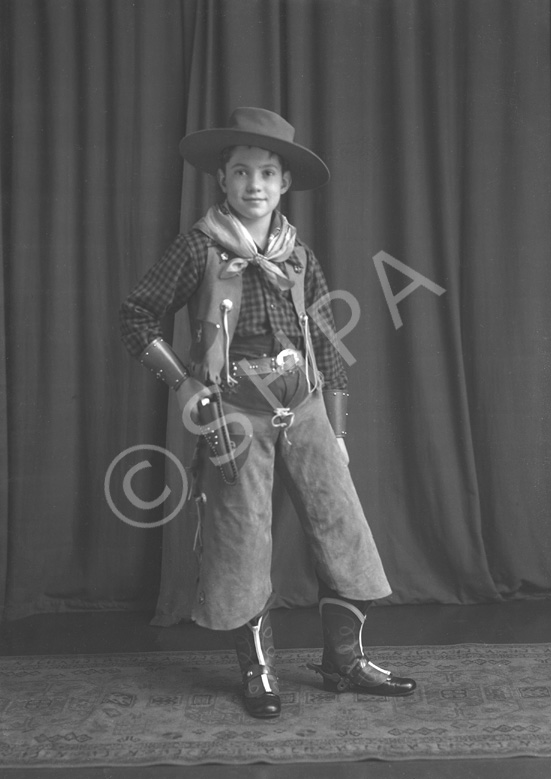 Andrew Chalmers dressed in a cowboy costume for a fancy dress party c1947. (see also refs: 33898, 39.....