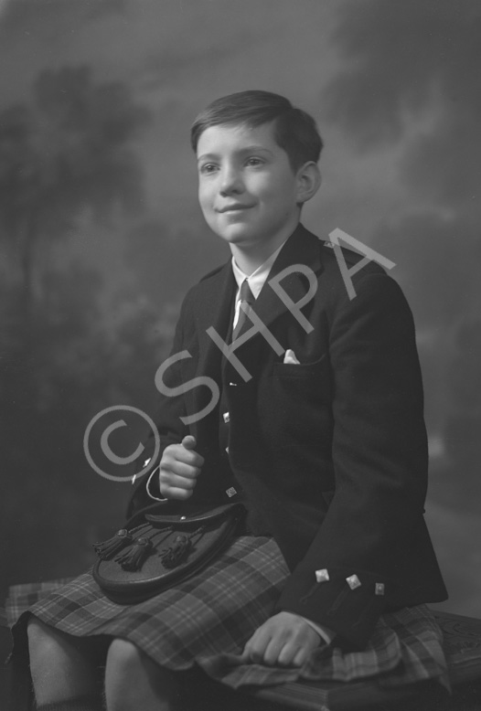 Andrew Chalmers dressed in school uniform for Sundays at the Loretto Boarding School, Edinburgh. (see also refs: 33898, 39550 and 45474). He was a grandson of the famous photographer Andrew Paterson (1877-1948).