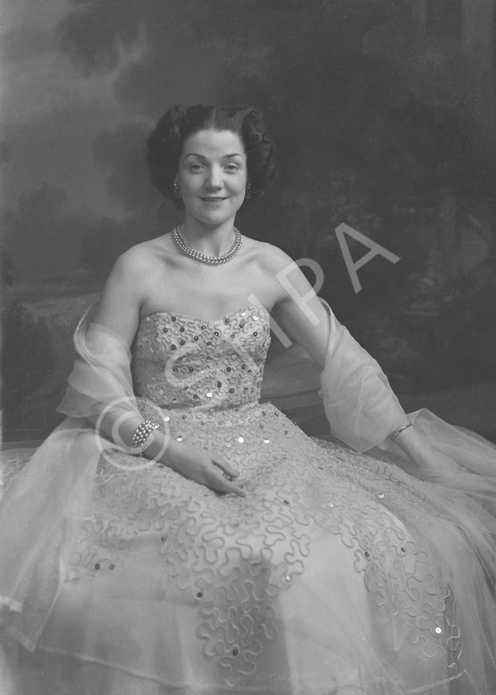 Miss Cairns, Station Hotel, Inverness, in ball gown, seated. Other images also under code 42904.