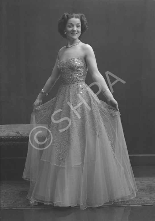 Miss Cairns, Station Hotel, Inverness, in ball gown, standing. Other images also under code 42904.