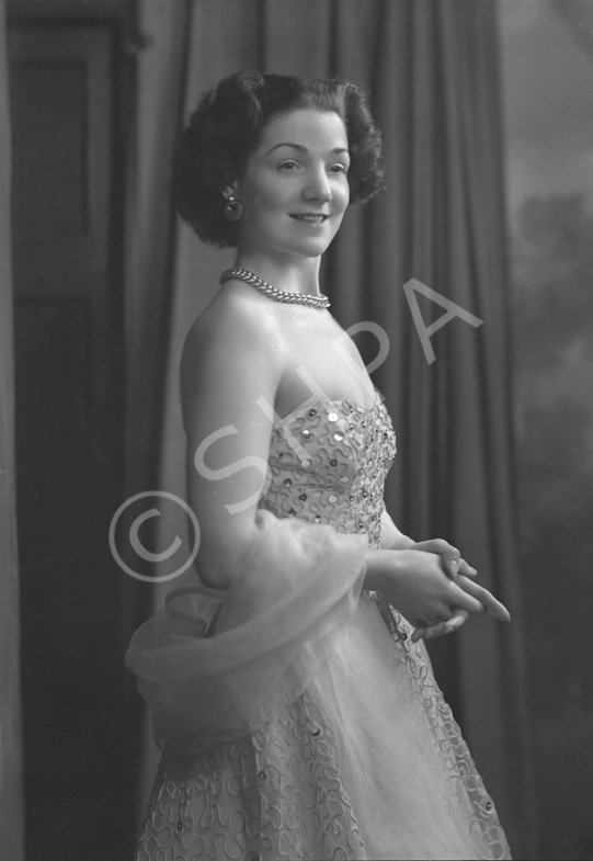 Miss Cairns, Station Hotel, Inverness, in ball gown, standing. Other images also under code 42904.