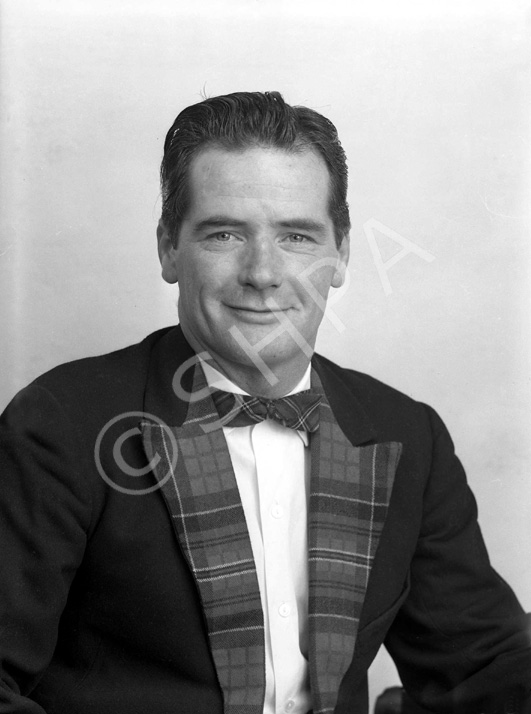 Stewart Ross, Grampian Records. Inverness singer and songwriter born in Merkinch in 1929. A well known performer from the 1960s-1980s, signed with Grampian Records in February 1965, about the time this portrait was taken. He wrote 'My Bonnie Maureen' which sold over 350,000 copies for Daniel O'Donnell. He also contributed lyrics to Calum Kennedy's famous recording of 'The Dark Island.' The Am Baile website have published a radio interview with him from 1988 and the songs he wrote are now more widely available via YouTube and MP3 download. 'The Dark Island', sung by Daniel O' Donnell, was in the top thirty of the album charts at the end of 2018. Stewart Ross died in 1993. (Information kindly provided by his son, Alan Ross).