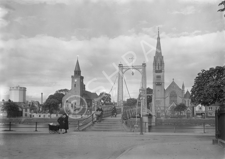 Greig Street Bridge over the River Ness, Inverness, showing old gasworks, cyclist and mothers with p.....