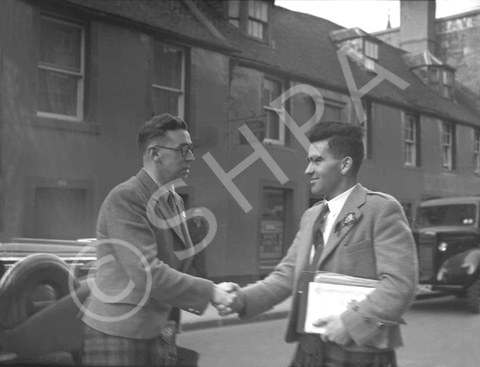 Captioned 'The Mod 1936, outside Cummings Hotel with Clarkie's Bar in the background.' Church Street, Inverness.* 