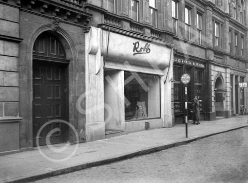 Robb in Union Street, Inverness. The Art Deco facade has gone and is now occupied by the British Heart Foundation, with the Glass & China Warehouse next door now housing Jessops. Further along, Stewart's Bar is now MacCallums. The carved stone face above the heavy door at the left has also disappeared, although others along the facade of the building (The White House Bistro) remain.* 