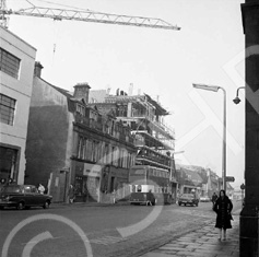 Building and construction of Caledonia House, now the Penta Hotel in Academy Street, Inverness. Originally the site of the Empire Theatre which was demolished in 1971, Caledonia House first appears in the Valuation Rolls of 1973-74. DE Shoes occupied the corner site for many years, next to the rear car park entrance of the Cummings Hotel (which is now the Hush Lounge Bar). The double decker bus is parked outside the building once occupied by Teddy Mountain.*