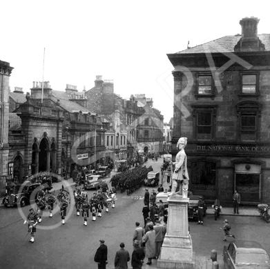 March past Station Square, Academy Street, Inverness. Possibly the Pipes and Drums of the Depot Seaforth, Fort George, leading a draft of soldiers to Inverness Station. *