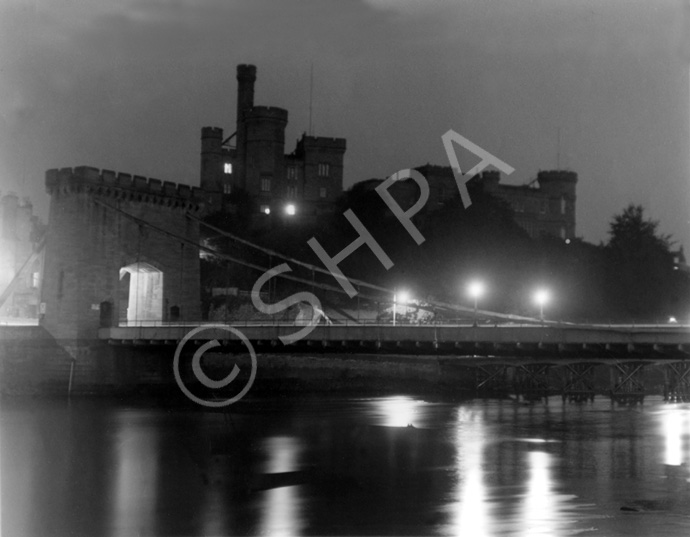 Inverness Castle from the river, featuring the old bridge at night. Spans of the 'temporary bridge' can be seen upriver beneath the old bridge. Courtesy John and Aithne Barron. *