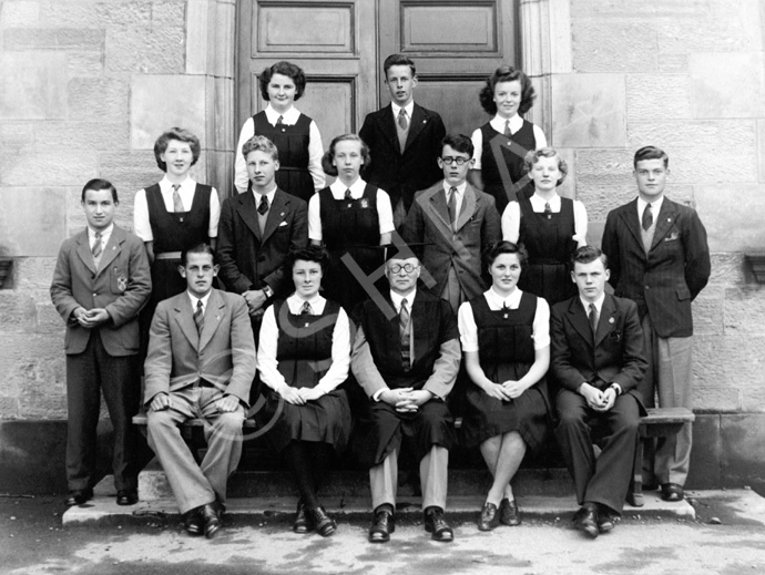 Inverness Royal Academy Prefects 1944-1945. Rear: Sheila Urquhart, Donald Campbell, Wilma MacDonald. Middle: Thomas Forrester, Evelyn Cameron, Allan Cook, Norma MacDougall, William Cattell, Muriel Riggs, Angus MacLeod. Front: Hamish Gray (VC from 03.01.1945), Christina Fraser (VC from 17.04.1945), Rector D.J MacDonald, May Murray, James Nairn (VC to Dec 1944, C from 03.01.1945) (Courtesy Inverness Royal Academy Archive IRAA_042).