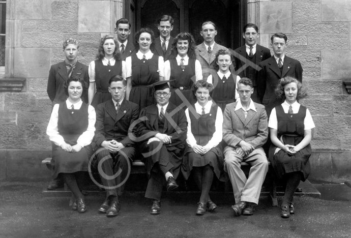 The first Prefects at the Inverness Royal Academy, appointed in May 1944 by the then new Rector D.J MacDonald. Rear: Andrew MacLaren, John Hill, Deverell Neill, James McPhee. Middle: Allan Cook, Evelyn Cameron, Eiona Moir, Irene Stewart, Marjory MacVinish, Simon MacMillan. Front: Mary Wylie, Callum MacAulay (C), Rector D.J MacDonald, Margaret Stewart (VC), James Cattell (VC), Isobel Mackay. (Prefect Jas Jackson left half-way through the term, replaced by Andrew MacLaren.) (Courtesy Inverness Royal Academy Archive IRAA_043).