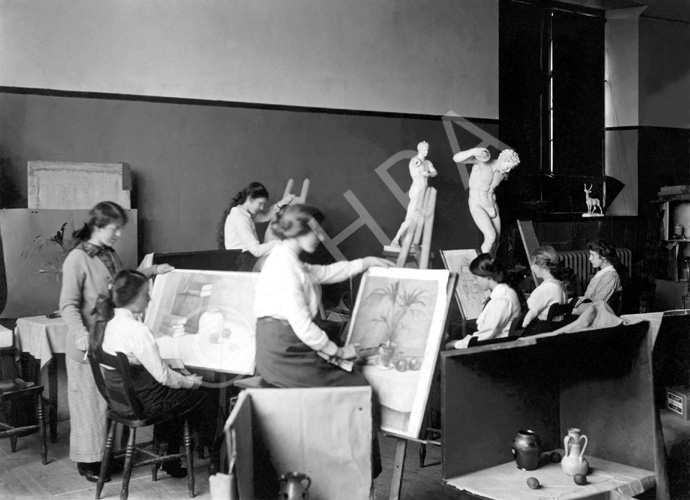 Inverness Royal Academy Higher Drawing Room, 1912. Between 1895-1980 the IRA was located in the Midmills building, currently the UHI-Inverness College (2013). The classroom scene was photographed at the time of the completion of the first extension to the Academy, running along Midmills Road opposite the side entrance to the Crown Church. The accommodation was shared in the early years with Inverness High School, when that school occupied the building which now houses the Crown School, only a short distance away. Accommodation included rooms for science and art, with a gymnasium and these are 'posed' publicity shots. (Courtesy Inverness Royal Academy Archive IRAA_056).