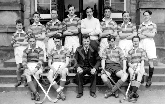 Shinty 1949-1950. Rear: William MacKenzie, James Griffiths, Tom Hay, George MacKenzie, Harry MacKenzie, Walter Bullock, Ross Martin, Donald MacKenzie. Front: Malcolm Fraser, Hugh Fraser,      Mr Stuart, Alistair MacInnes, Rod Norman MacSween. (Courtesy Inverness Royal Academy Archive IRAA_063).