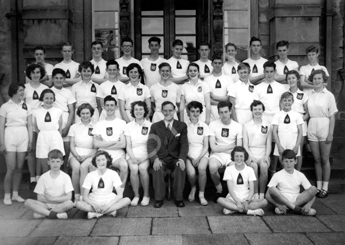 Inverness Royal Academy Athletics 1953-1954. Rear: A. Livingstone, J. Robertson, J. Taylor, C. Ross, R. Paterson, William Ford, J. MacLellan, I. Robin, D. Moir, K. Burrell, A. Finlayson. Middle: J. MacMillan, K. Gardener, D. Murray, I. Nicol, I. Rose, D. Robin, J. Campbell, J. Wylie, A. Sinclair, J. Urquhart, E. Farquhar, J. Cameron. Front: J. MacGillivray, D. Duncan, A. Robertson, A. MacLeod, A. Sinclair, Mr Murray, P. MacLeod, D.E MacLean, D. Lamont, D. Steele, D. Hamilton. (Courtesy Inverness Royal Academy Archive IRAA_079).