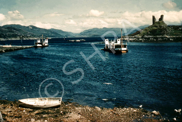 The ruins of Castle Moil (Dunakin Castle) occupies a headland above the village of Kyleakin facing the village of Kyle of Lochalsh across the strait. (Courtesy James S Nairn Colour Collection). ~ *