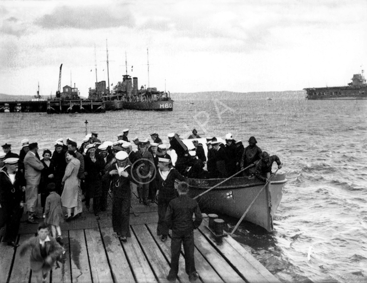 People at Invergordon queuing to take a trip by speedboat to the wreck of the HMS Natal c1932-1938. .....